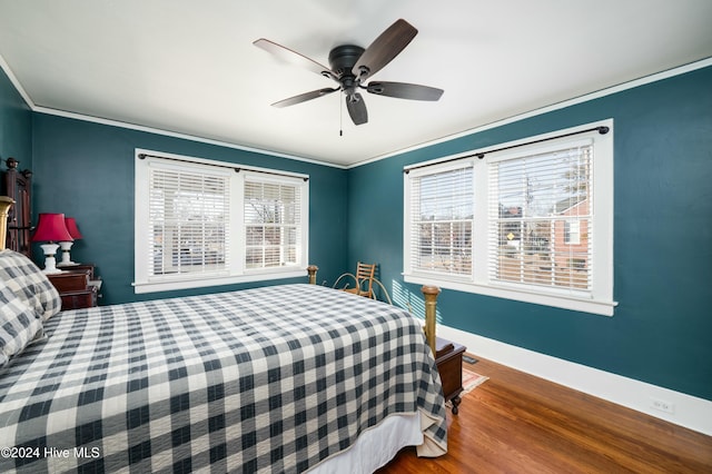 bedroom featuring wood-type flooring, ornamental molding, and ceiling fan