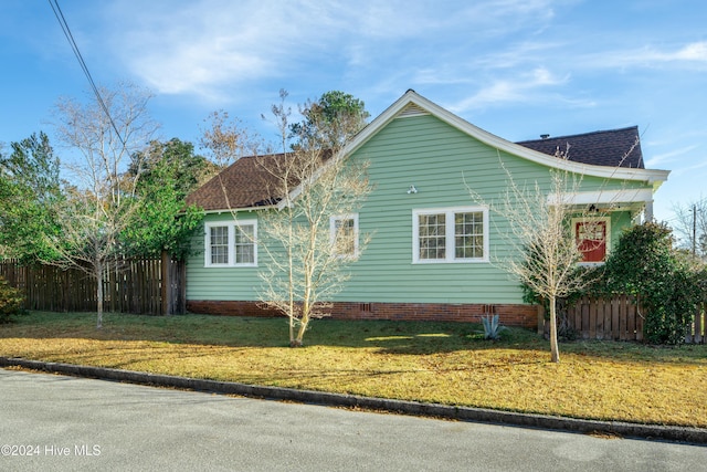 view of side of property with a yard