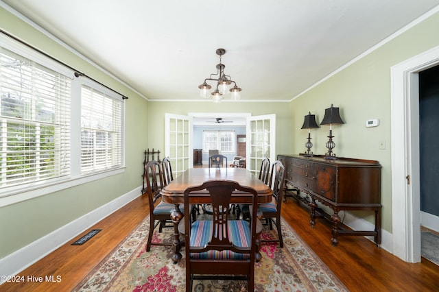 dining area featuring ornamental molding, plenty of natural light, and dark hardwood / wood-style flooring