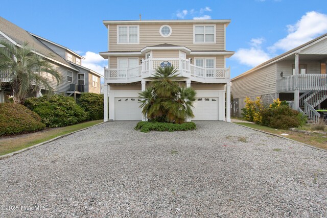 17 Leland St, Ocean Isle Beach, NC 28469 - beach home featuring an attached garage, gravel driveway, and a balcony
