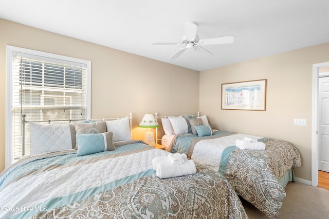 carpeted bedroom featuring ceiling fan