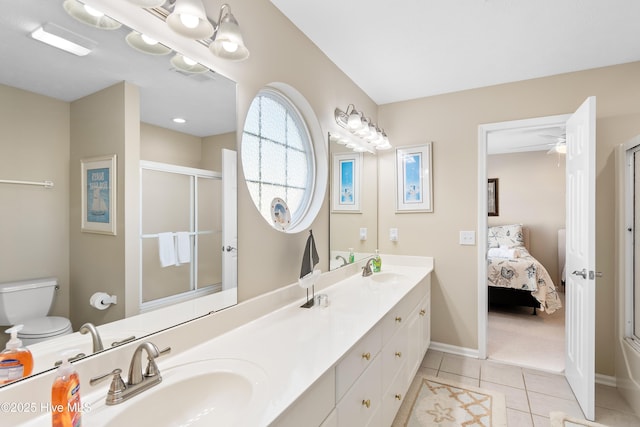 bathroom with toilet, tile patterned flooring, a shower with shower door, and vanity