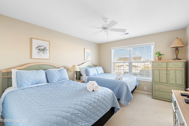 bedroom featuring ceiling fan and light carpet