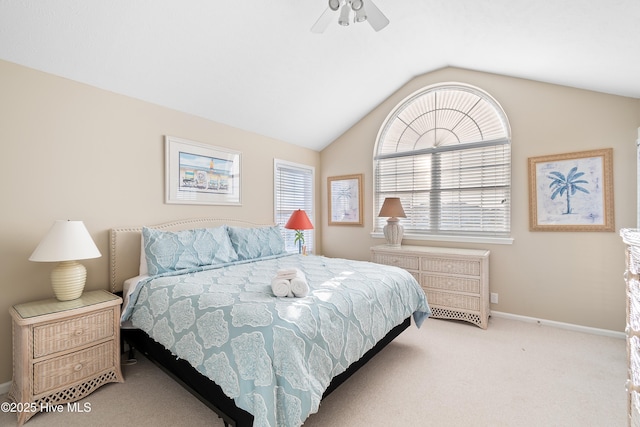 carpeted bedroom with ceiling fan and lofted ceiling