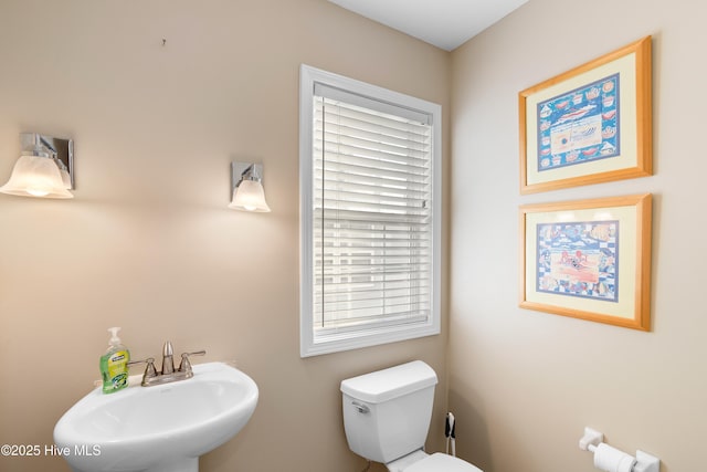 bathroom featuring sink and toilet