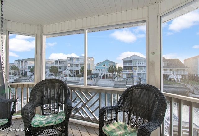 17 Leland St, Ocean Isle Beach, NC 28469 - sunroom featuring wood finished floors, a residential view, and plenty of natural light