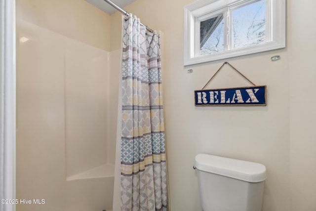 bathroom featuring toilet and walk in shower