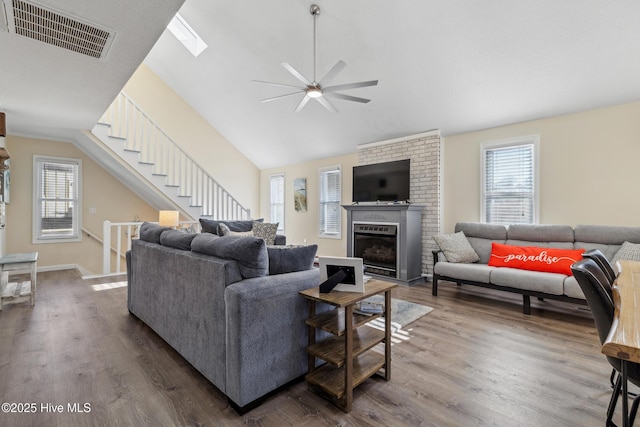 living room featuring plenty of natural light, dark wood-type flooring, and lofted ceiling