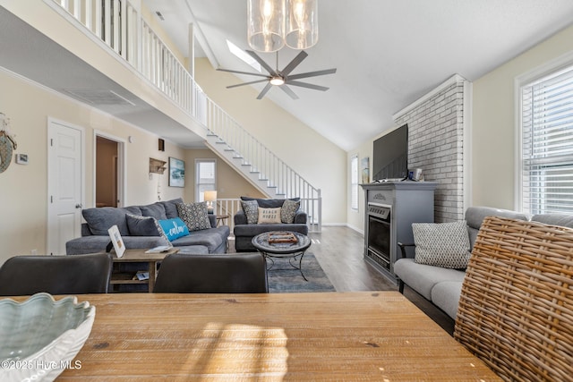 living room featuring dark wood-type flooring, ceiling fan, and high vaulted ceiling