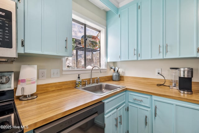 kitchen with blue cabinets, black dishwasher, sink, and butcher block countertops