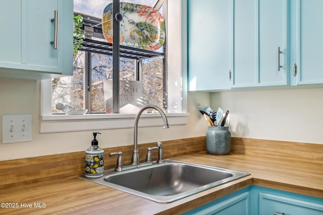 kitchen with sink and blue cabinetry