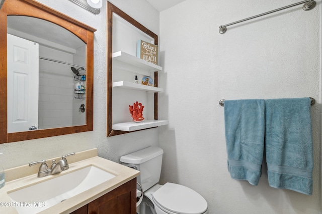 bathroom featuring vanity, a shower, and toilet