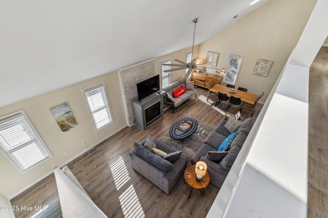 living room featuring lofted ceiling, hardwood / wood-style floors, and ceiling fan