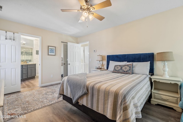 bedroom with hardwood / wood-style flooring, ceiling fan, and ensuite bathroom