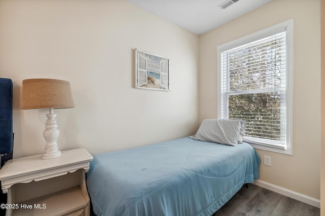 bedroom with dark wood-type flooring