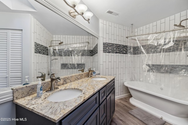 bathroom with vanity, wood-type flooring, and tile walls