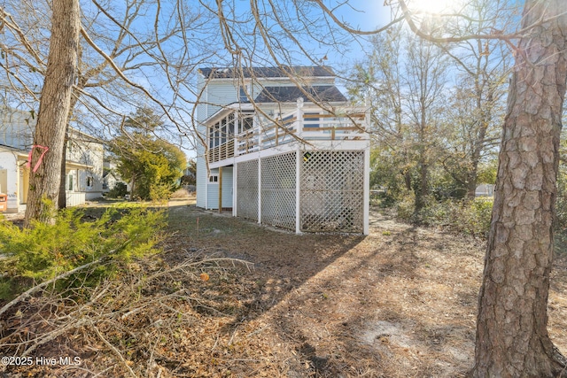 view of side of property with a wooden deck