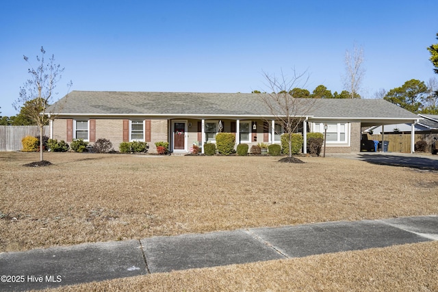 ranch-style home featuring a front yard and a carport