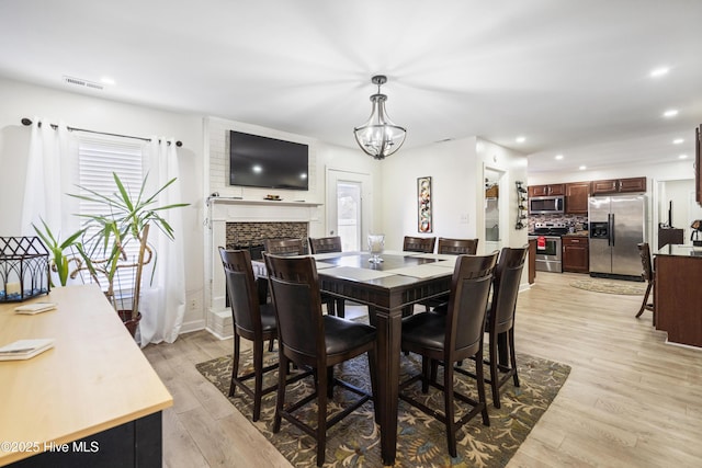 dining room featuring an inviting chandelier and light hardwood / wood-style floors