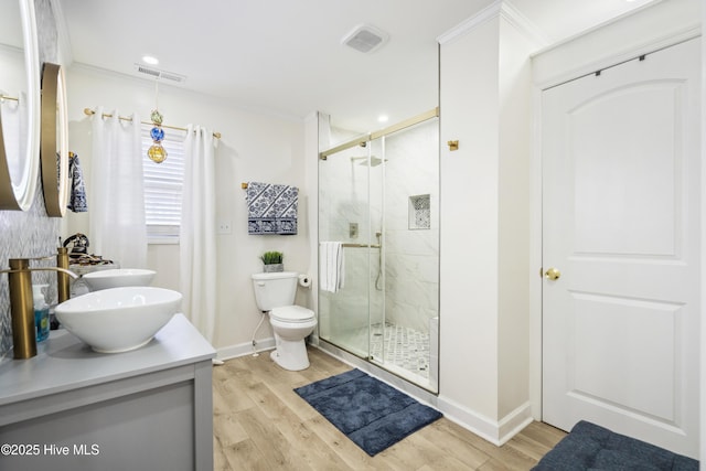 bathroom featuring vanity, toilet, hardwood / wood-style floors, and an enclosed shower