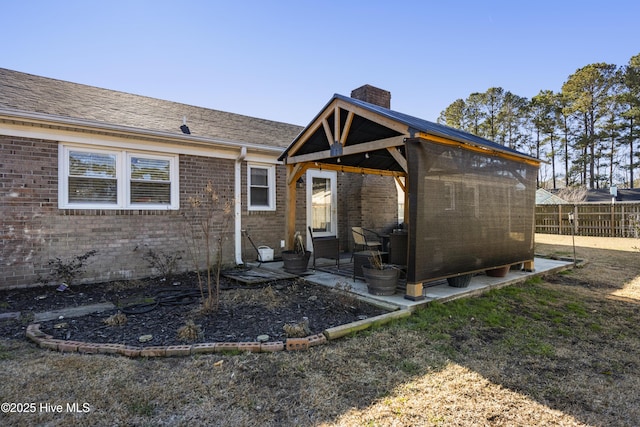 back of property featuring a gazebo