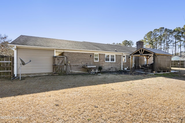 back of property with a lawn