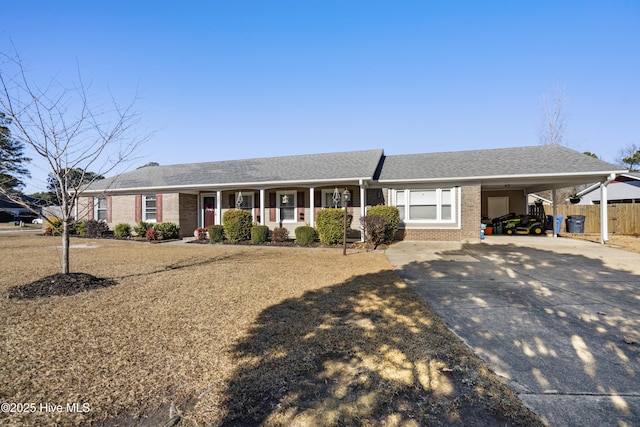 single story home featuring covered porch and a carport