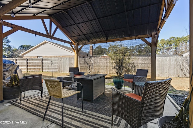 view of patio / terrace featuring an outdoor fire pit and a gazebo