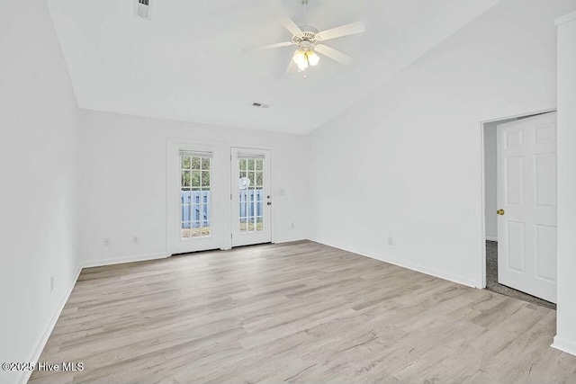 empty room featuring ceiling fan, visible vents, and wood finished floors