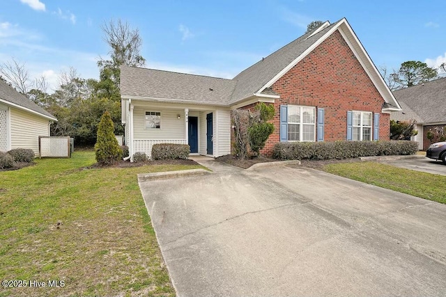 traditional-style home featuring covered porch, brick siding, and a front lawn