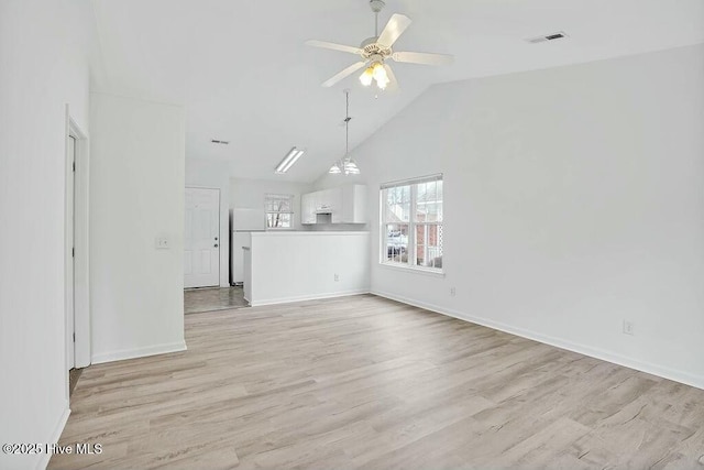 unfurnished living room with ceiling fan, high vaulted ceiling, light wood-style flooring, visible vents, and baseboards