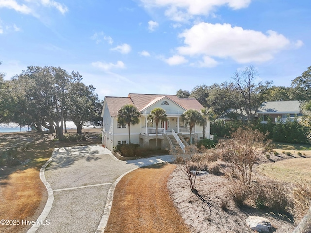 view of front of house with a porch and a water view