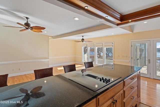 kitchen with black electric stovetop, ceiling fan, and light wood-type flooring