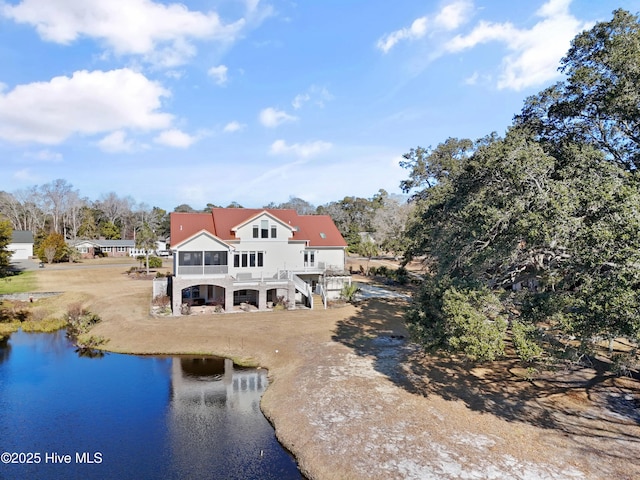 rear view of house featuring a water view