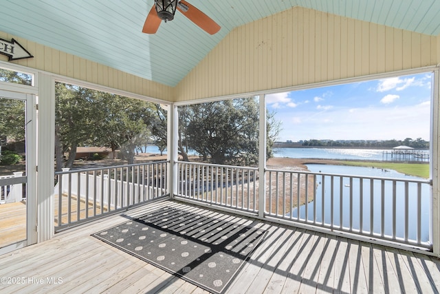 wooden deck with a water view and ceiling fan