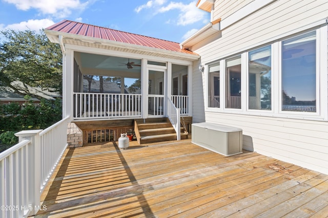 wooden deck with a sunroom and ceiling fan