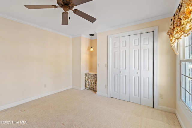 unfurnished bedroom with light colored carpet, ornamental molding, and a closet