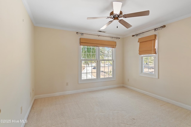 carpeted empty room featuring ornamental molding and ceiling fan