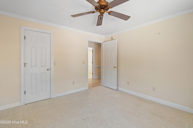 unfurnished bedroom with ornamental molding, light colored carpet, and ceiling fan