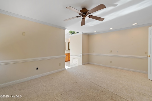 carpeted empty room featuring ceiling fan and ornamental molding