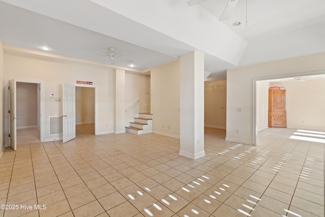 basement with light tile patterned floors and ceiling fan