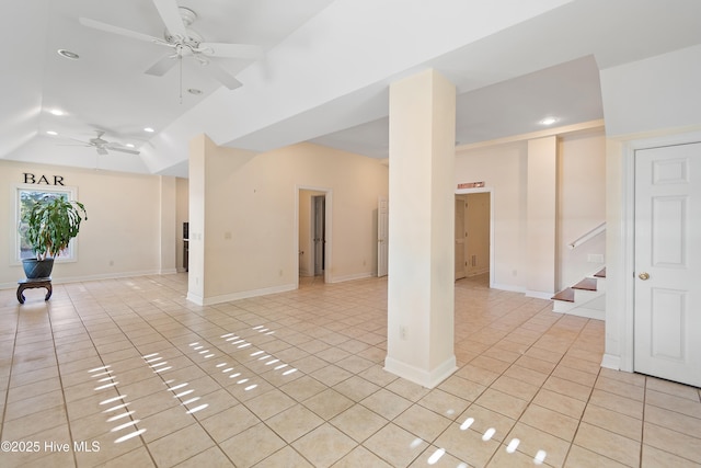 spare room with lofted ceiling, light tile patterned floors, and ceiling fan