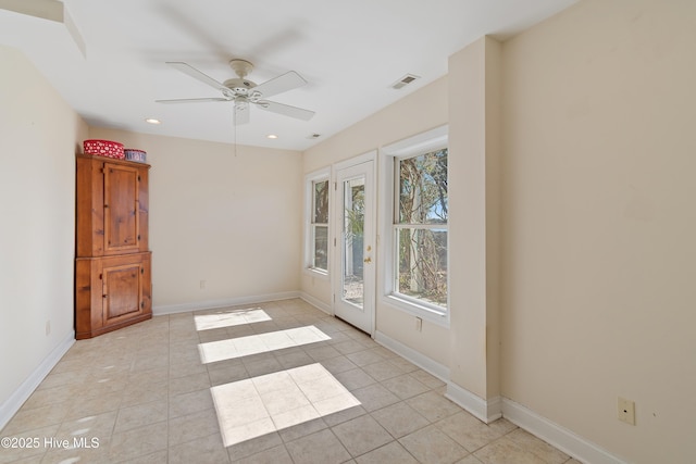 unfurnished room with light tile patterned floors and ceiling fan