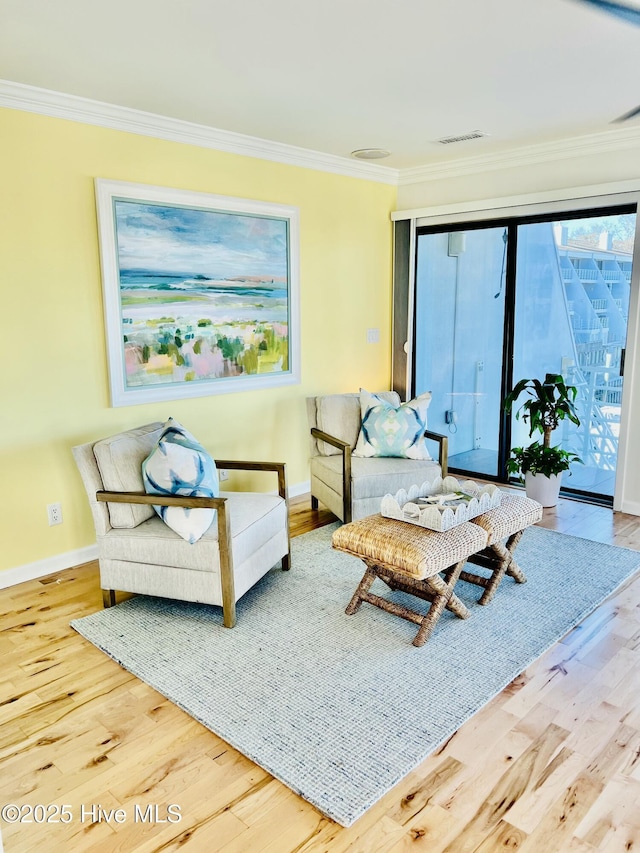 living room featuring hardwood / wood-style flooring and ornamental molding