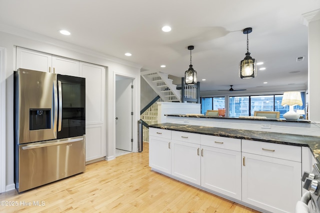 kitchen with white cabinetry, dark stone counters, stainless steel fridge with ice dispenser, and pendant lighting