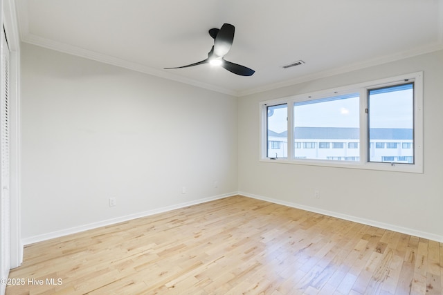 unfurnished room featuring crown molding, ceiling fan, and light wood-type flooring