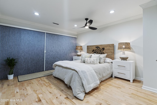 bedroom featuring light hardwood / wood-style flooring, ornamental molding, and ceiling fan