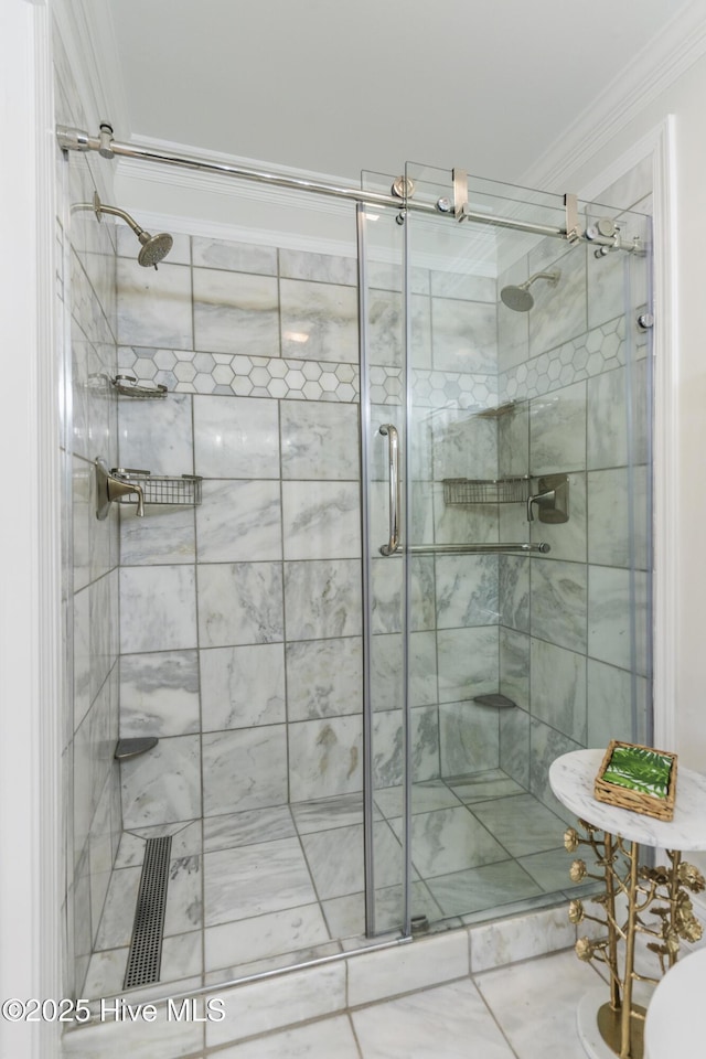 bathroom with ornamental molding, a shower with door, and tile patterned flooring