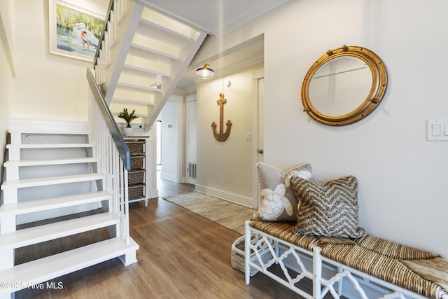 entryway with hardwood / wood-style flooring and ornamental molding