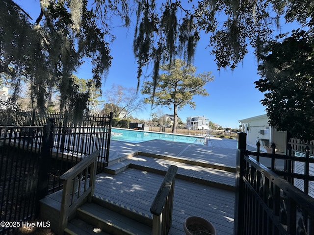 view of swimming pool with a wooden deck